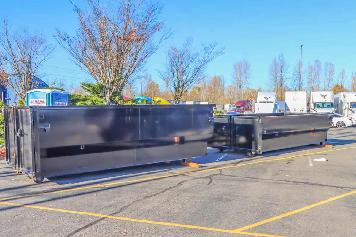 Professional dumpster rental service with roll-off container on residential driveway in Homer